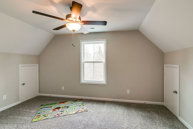 additional living space featuring ceiling fan, carpet, and lofted ceiling