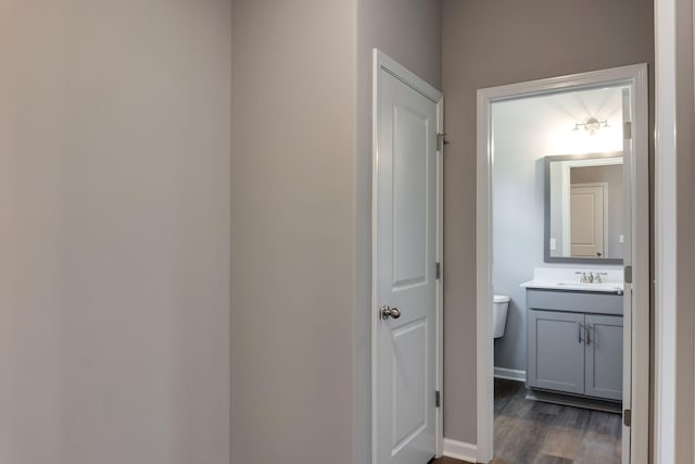 bathroom featuring hardwood / wood-style flooring, toilet, and vanity