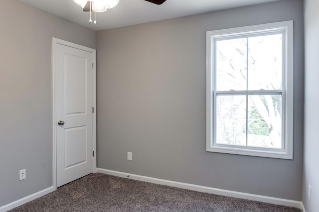 carpeted spare room with ceiling fan