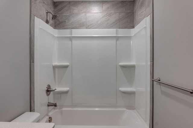 bathroom with shower / bath combination and toilet