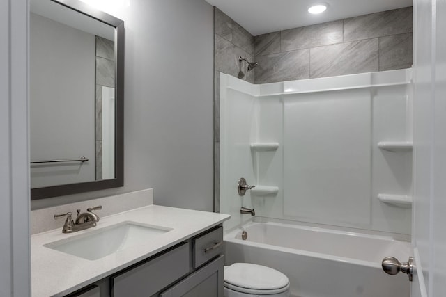 full bathroom with toilet, vanity, and tiled shower / bath combo