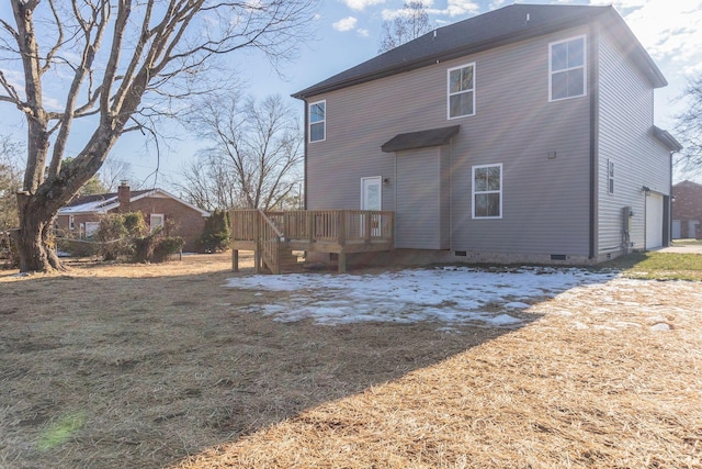 back of house featuring a wooden deck and a garage