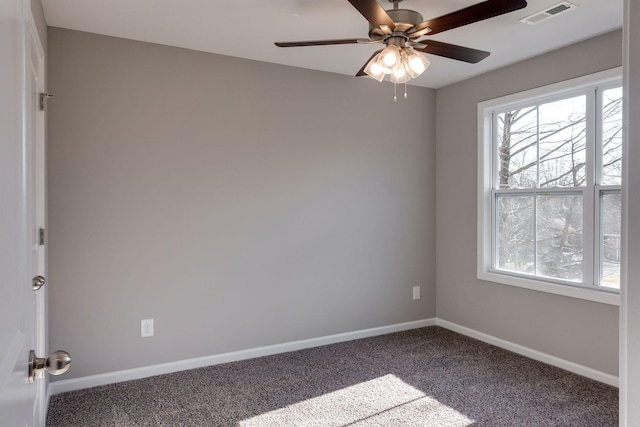 carpeted spare room featuring ceiling fan