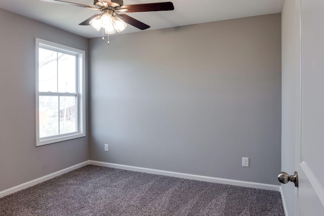 carpeted spare room featuring ceiling fan and a wealth of natural light