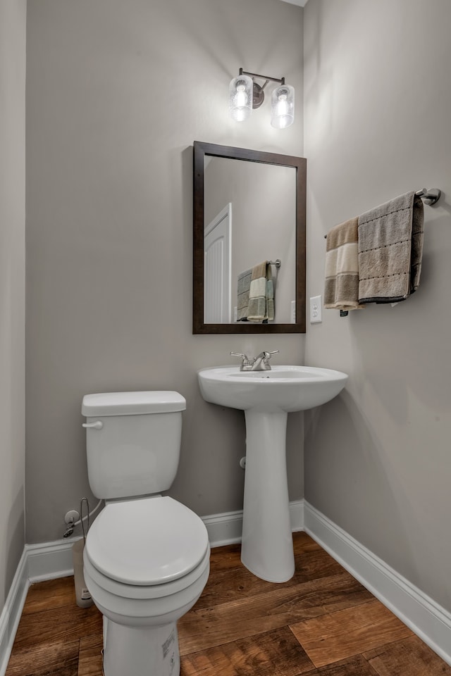 bathroom featuring hardwood / wood-style floors and toilet