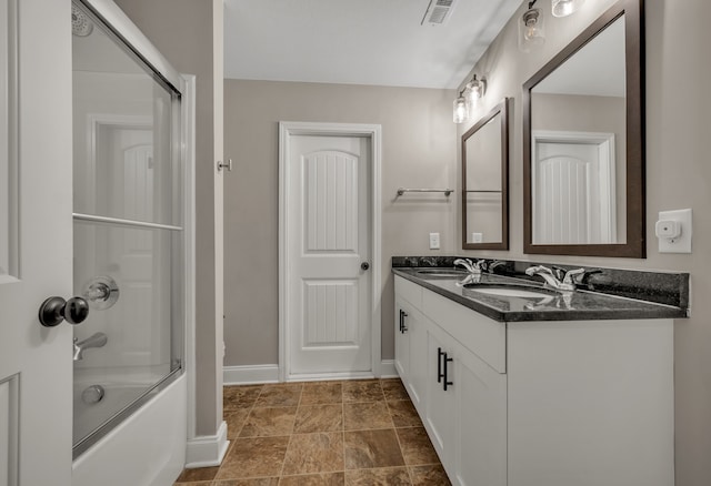 bathroom with enclosed tub / shower combo and vanity