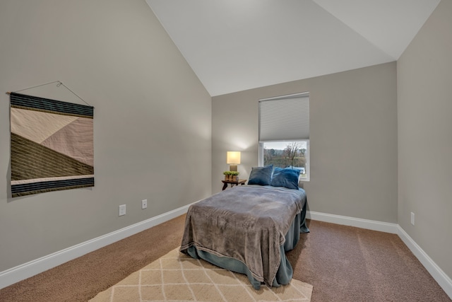 bedroom with vaulted ceiling and carpet