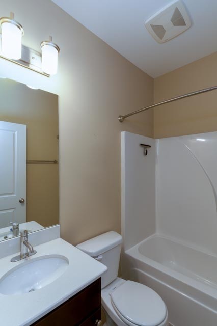 full bathroom featuring shower / bathing tub combination, vanity, and toilet