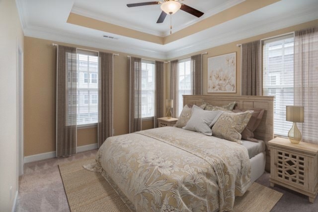 bedroom featuring light colored carpet, multiple windows, and ceiling fan