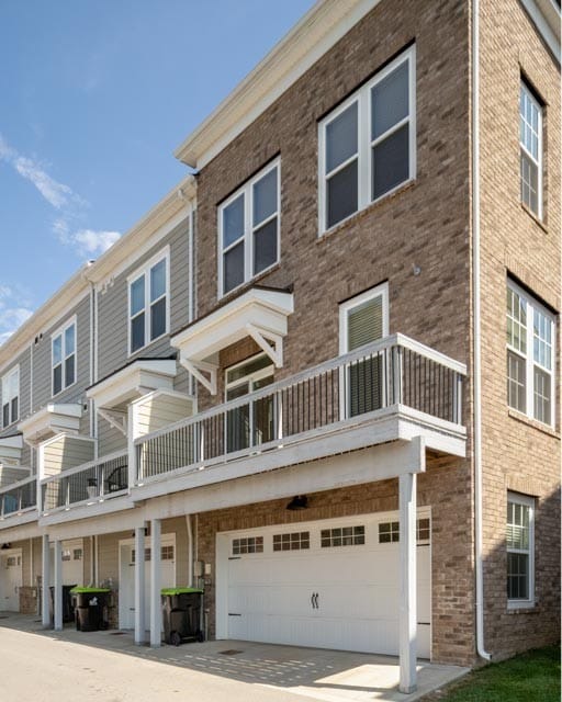 view of front of home with a garage and a balcony