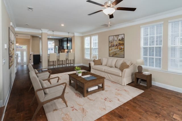 living room featuring ornamental molding, hardwood / wood-style flooring, and ceiling fan