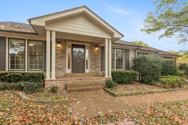 view of exterior entry with a porch