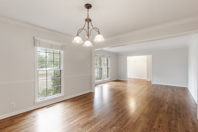 unfurnished room with wood-type flooring, crown molding, and an inviting chandelier