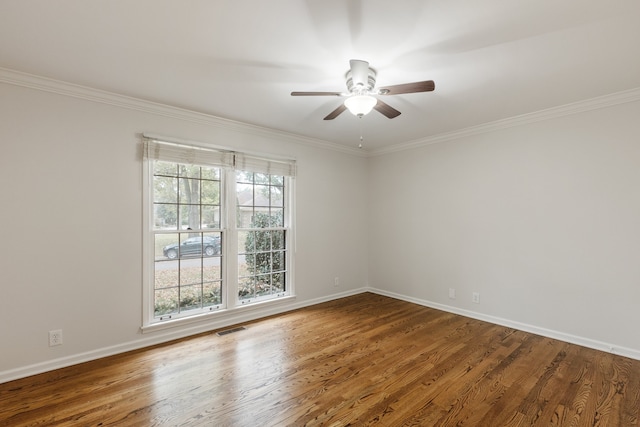 empty room featuring ceiling fan, wood-type flooring, and ornamental molding