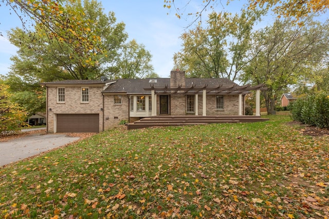 back of house with a pergola and a lawn