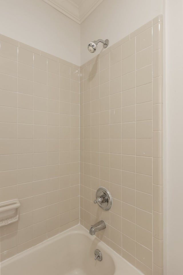 bathroom featuring ornamental molding and tiled shower / bath combo