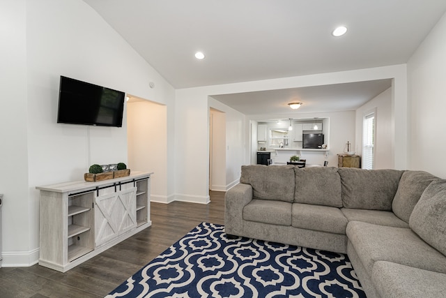 living room with dark hardwood / wood-style flooring and vaulted ceiling