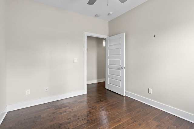 empty room with dark wood-type flooring and ceiling fan