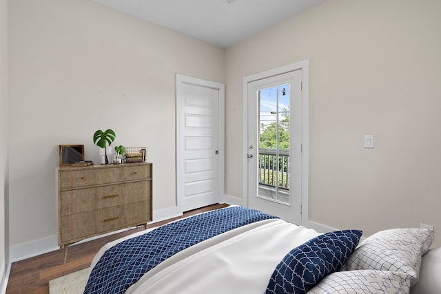 bedroom with access to outside and dark wood-type flooring