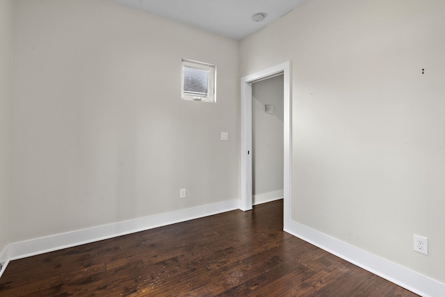 spare room featuring dark wood-type flooring