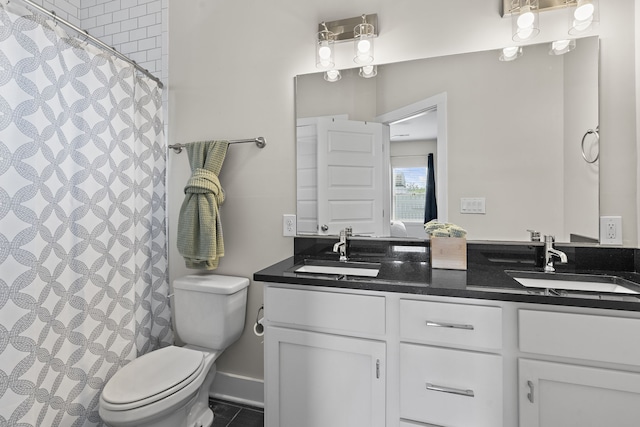 bathroom with a shower with shower curtain, tile patterned floors, vanity, and toilet