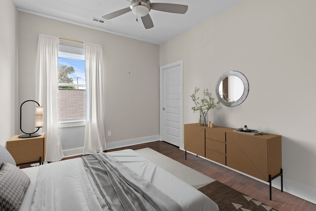 bedroom featuring ceiling fan and dark hardwood / wood-style floors