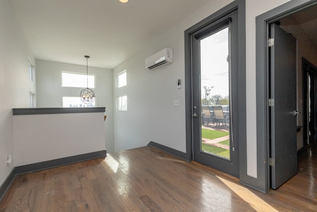 entryway featuring a wall mounted AC and dark hardwood / wood-style floors