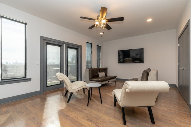 living room with hardwood / wood-style floors and ceiling fan