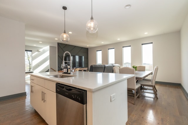 kitchen featuring an island with sink, white cabinetry, plenty of natural light, and dishwasher