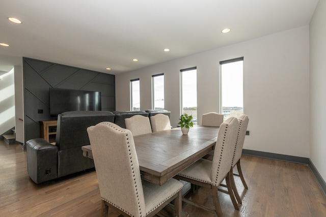 dining room featuring hardwood / wood-style flooring and a healthy amount of sunlight