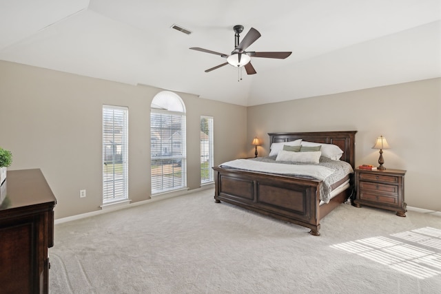 bedroom with ceiling fan, light colored carpet, and vaulted ceiling