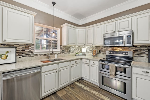 kitchen with white cabinetry, sink, hanging light fixtures, dark hardwood / wood-style flooring, and appliances with stainless steel finishes