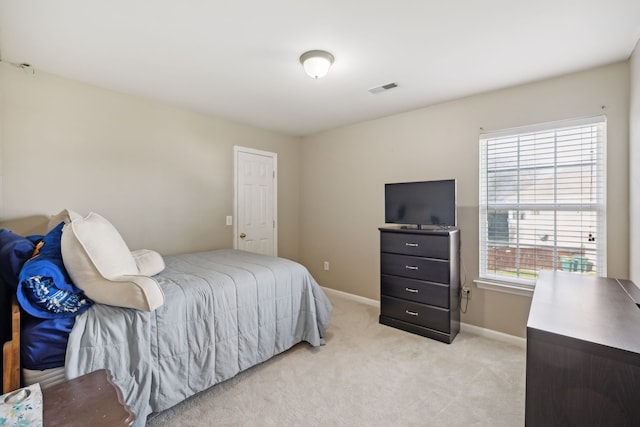 carpeted bedroom featuring multiple windows