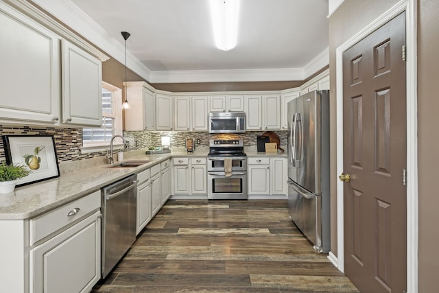 kitchen with sink, stainless steel appliances, dark hardwood / wood-style flooring, decorative light fixtures, and ornamental molding