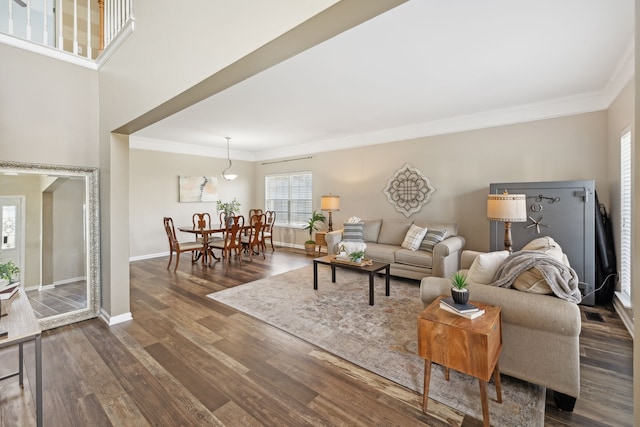 living room featuring dark hardwood / wood-style floors and crown molding