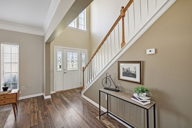 foyer entrance featuring crown molding and dark hardwood / wood-style floors