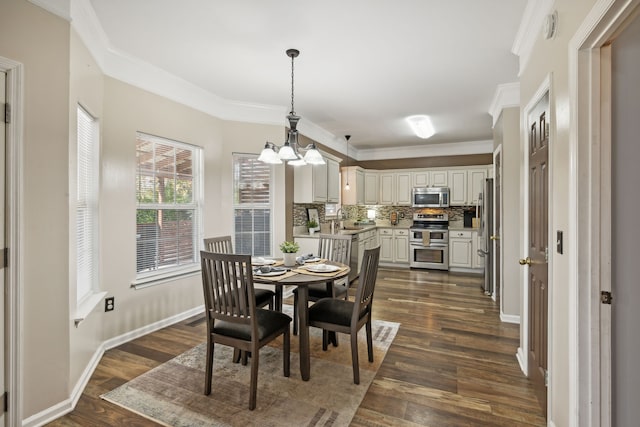 dining space featuring crown molding, dark wood-type flooring, and sink