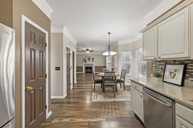 kitchen with stainless steel dishwasher, dark hardwood / wood-style floors, light stone countertops, and crown molding