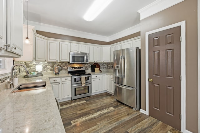 kitchen featuring stainless steel appliances, dark wood-type flooring, sink, pendant lighting, and white cabinets