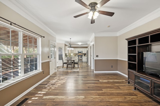 unfurnished living room with dark hardwood / wood-style floors, ornamental molding, and ceiling fan with notable chandelier