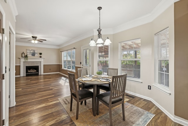 dining room with dark hardwood / wood-style flooring, plenty of natural light, and crown molding