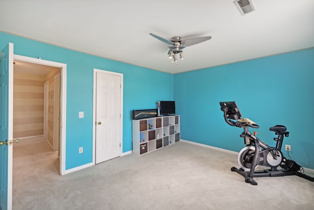 workout area featuring light carpet and ceiling fan