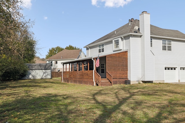 rear view of property featuring a yard and a storage shed