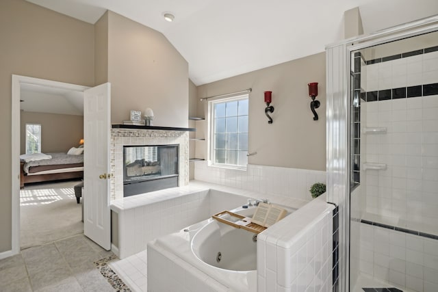 bathroom featuring plus walk in shower, a healthy amount of sunlight, tile patterned floors, and lofted ceiling