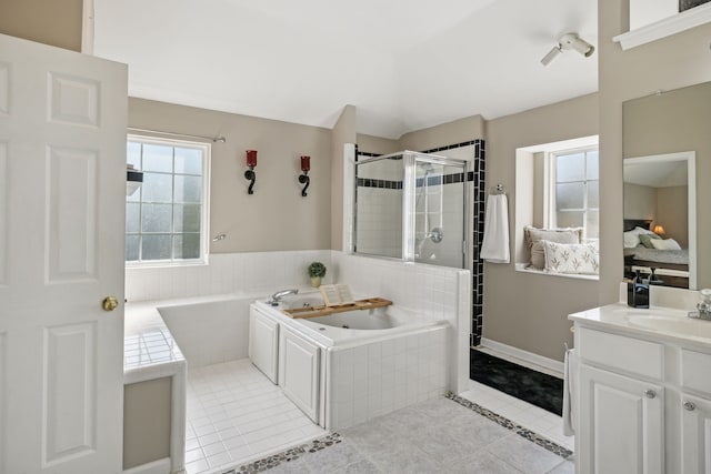 bathroom with tile patterned flooring, vanity, and independent shower and bath