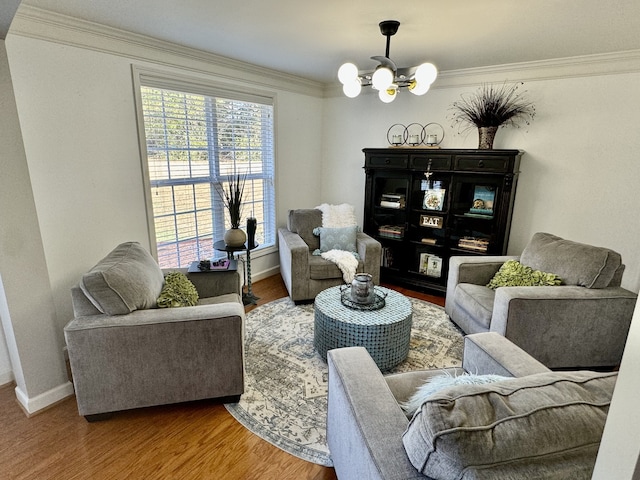 living room with hardwood / wood-style flooring, crown molding, and a notable chandelier