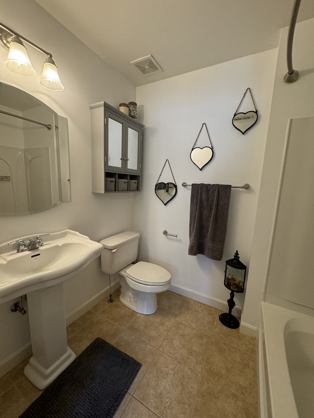 bathroom with toilet, tile patterned flooring, and separate shower and tub