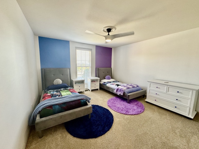 bedroom with ceiling fan and light carpet