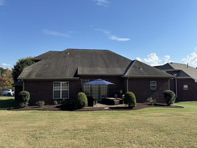 rear view of property with a patio and a yard