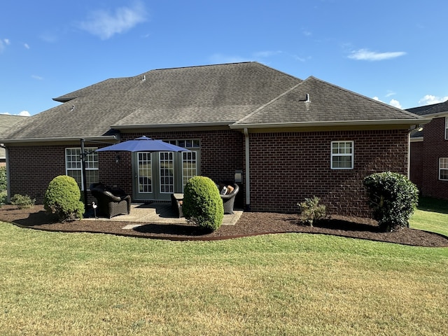 rear view of house with a patio area and a yard